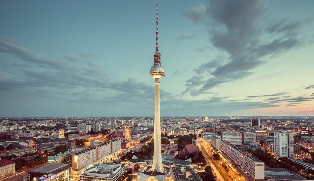 Aerial view of Berlin skyline with famous TV tower at Alexanderplatz and dramatic cloudscape in twilight during blue hour at dusk with retro vintage Instagram style nostalgic pastel toned filter effect, Germany